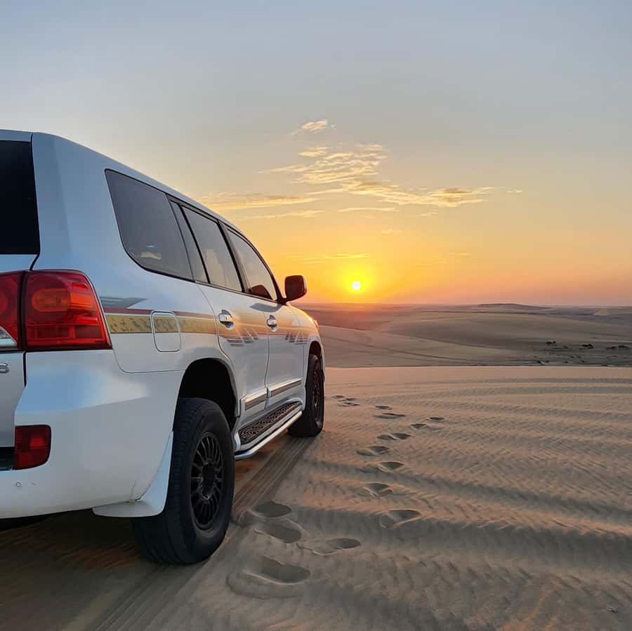 Doha: Desert Safari, Adventure, Sandboarding and Camel Ride - Sandboarding down soft golden dunes
