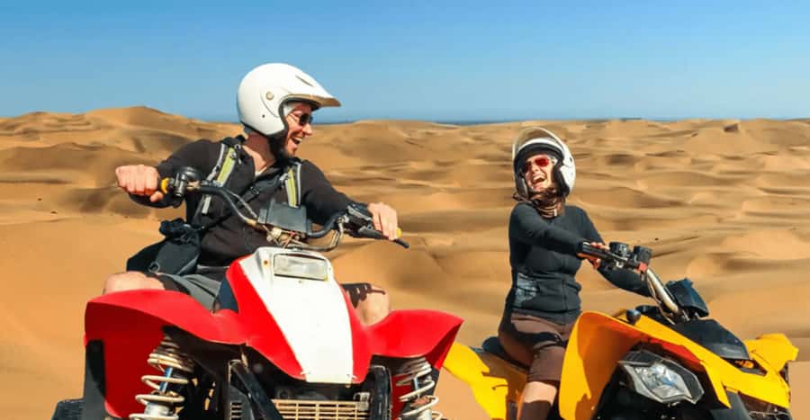 Doha: DesertSafari with Quad Bike, Camel Ride & Sandboarding - Sandboarding down the dunes