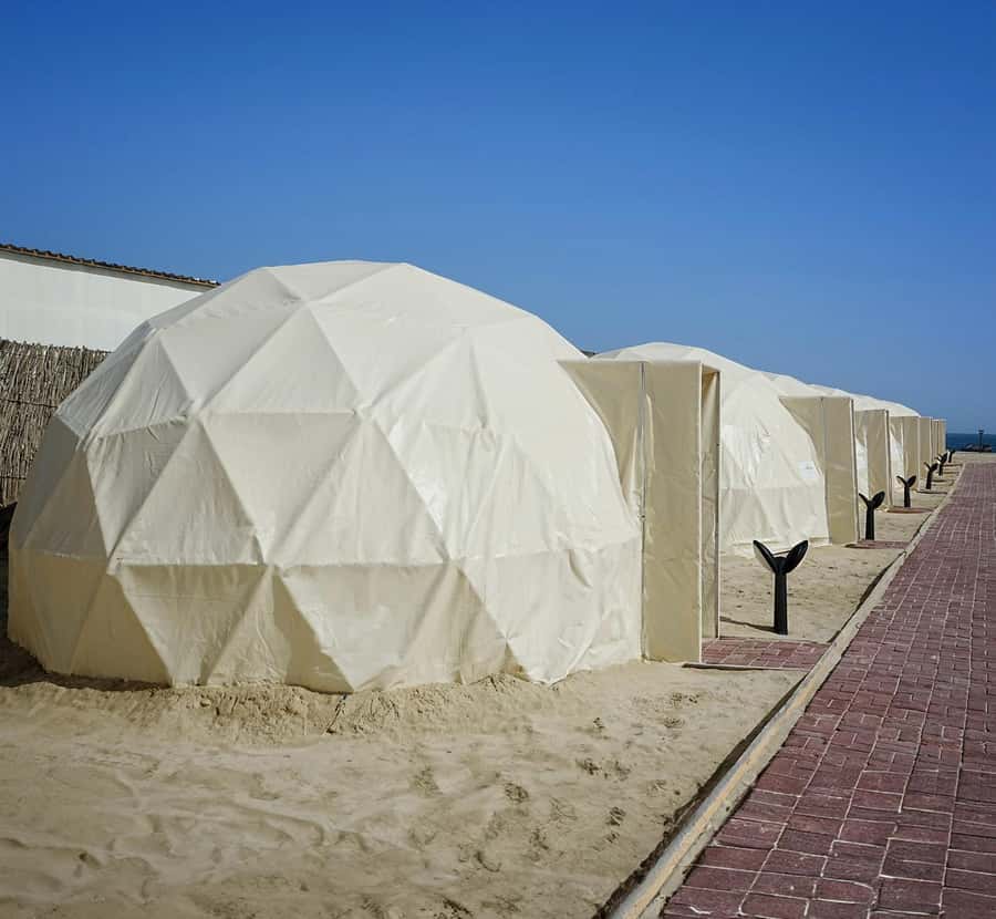 Doha: Overnight Desert Camping With BBQ Dinner & Breakfast - Sunset, swimming, and camp activities