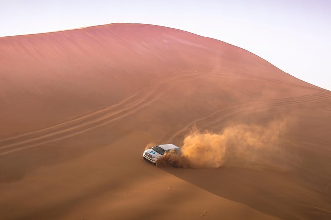Doha: Sunset Desert Safari, Camels, Sandboarding & Inland Sea - Sandboarding across the dunes