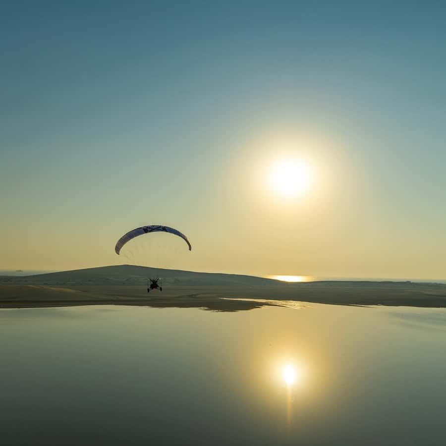 Qatar: Paratrike Air Tour with Hotel Transfers - Reaching Sealine Beach and preparing to fly